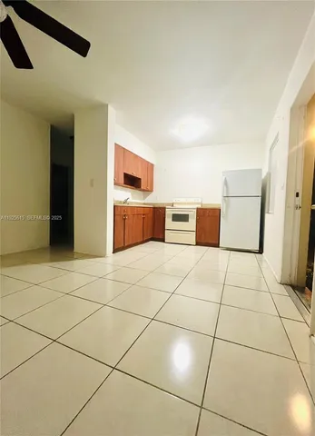 a kitchen with stainless steel appliances cabinets and stove top oven