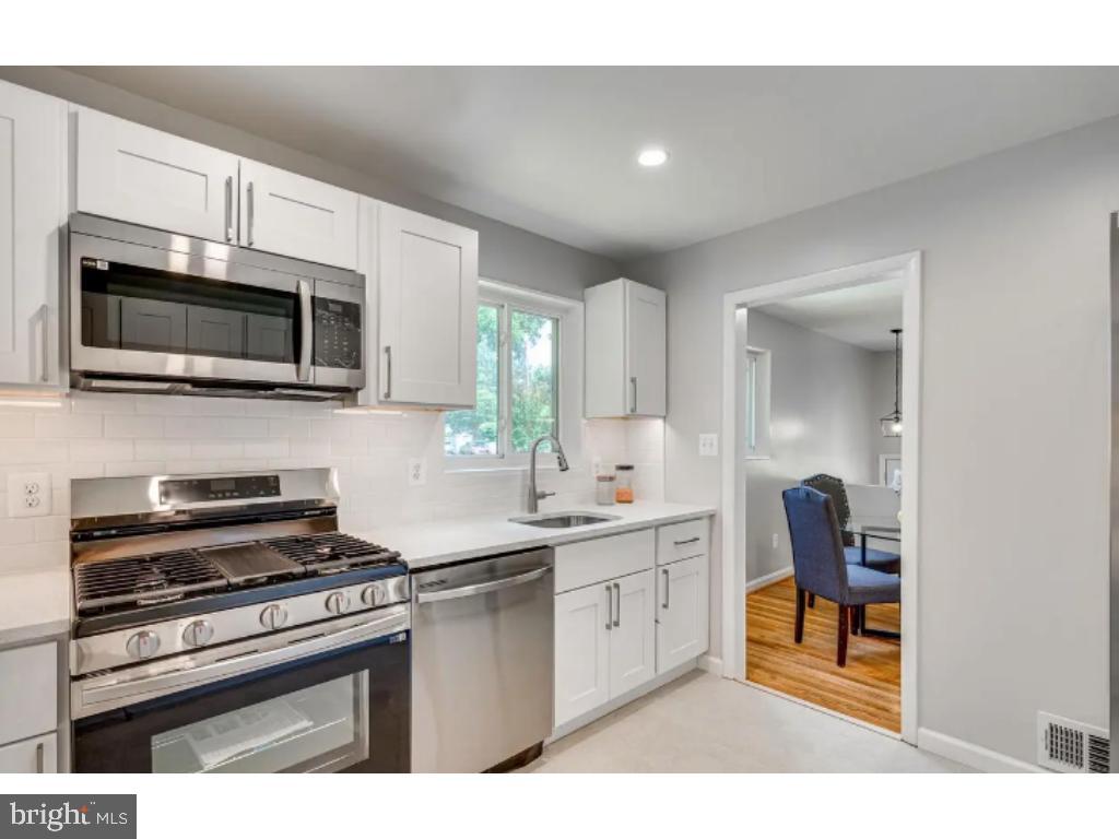 3919 Littleton Street Silver Spring, MD 20906 - Photo 6 of 17 a kitchen with stainless steel appliances a stove microwave and sink