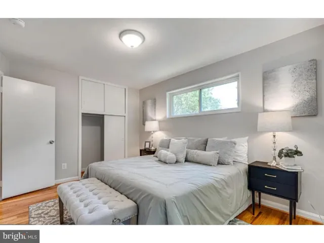 a bedroom with a bed and a lamp