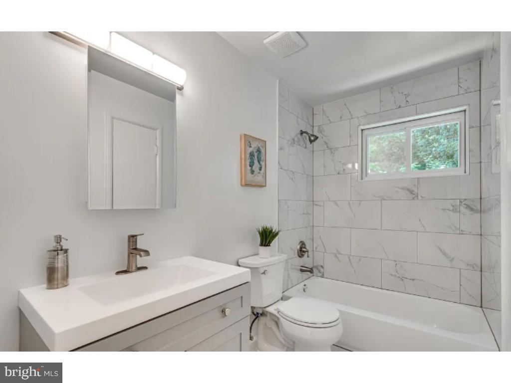 3919 Littleton Street Silver Spring, MD 20906 - Photo 9 of 17 a bathroom with a sink a toilet and a mirror
