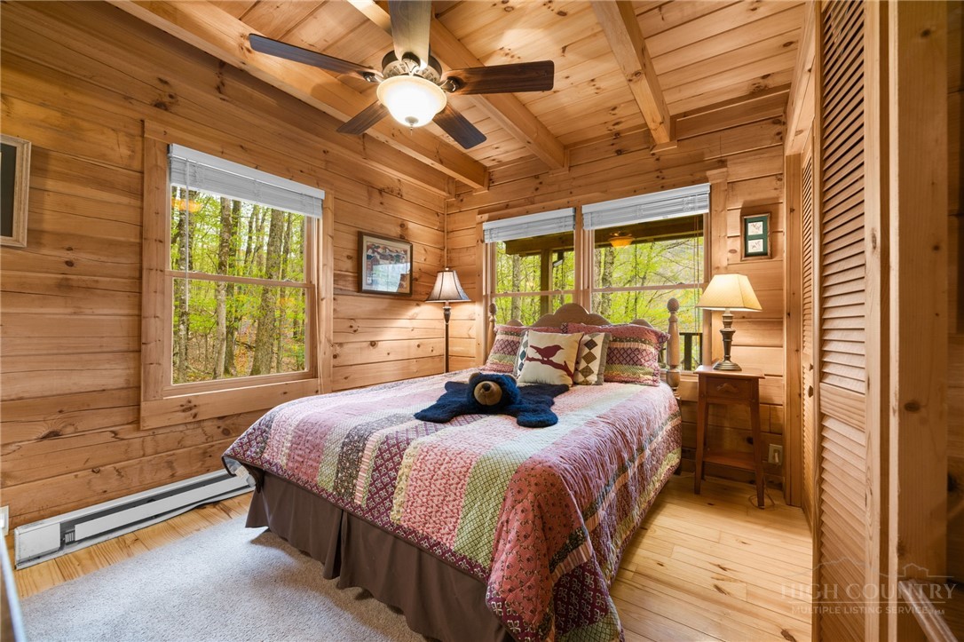 259 Greenbriar Road Beech Mountain, NC 28604 - Photo 17 of 41 a bed room with a bed and a chandelier