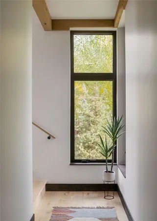 a view of small space with wooden floor and a window