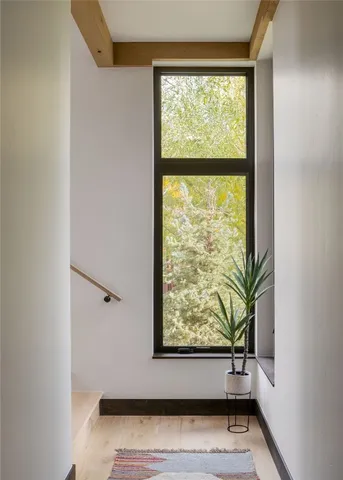 a view of small space with wooden floor and a window