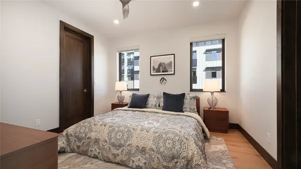 a bedroom with a bed and a painting on the wall