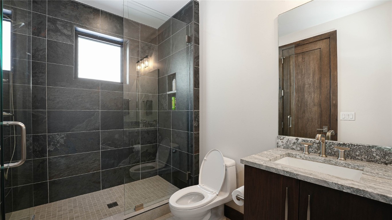 321 Riverview Way Steamboat Springs, CO 80487 - Photo 17 of 50 a bathroom with a sink a toilet a mirror and shower