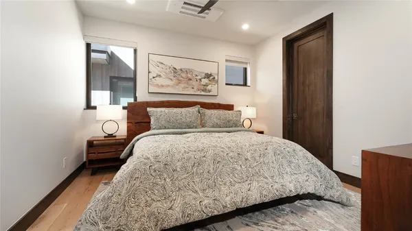 a bedroom with a bed and a painting on the wall