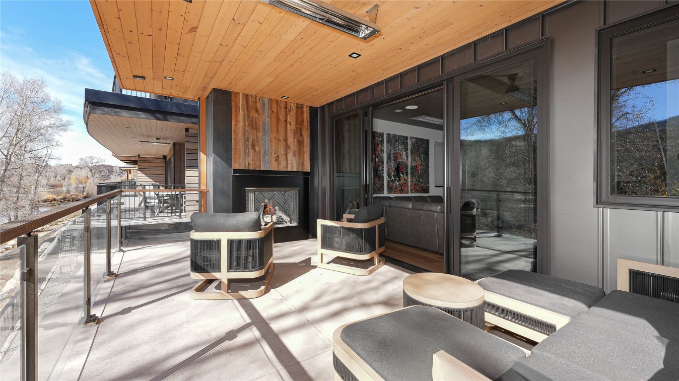 321 Riverview Way Steamboat Springs, CO 80487 - Photo 22 of 50 a room with furniture a flat screen tv and a fireplace