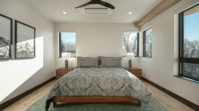 a bedroom with a large bed and a window