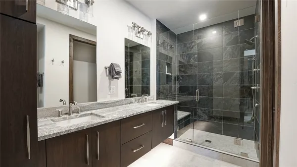 a bathroom with a shower sink and mirror