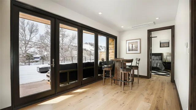 a dining room with furniture and wooden floor
