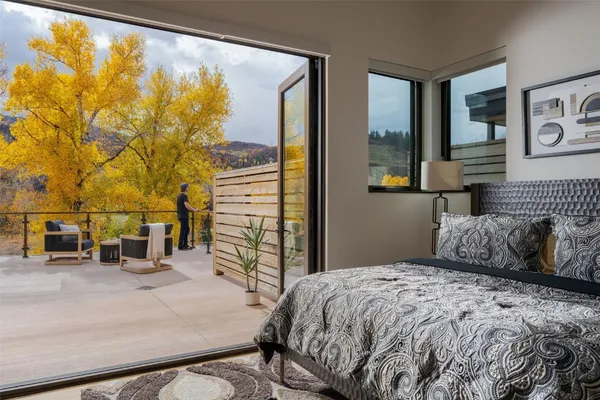 a bedroom with a bed and a painting on the wall