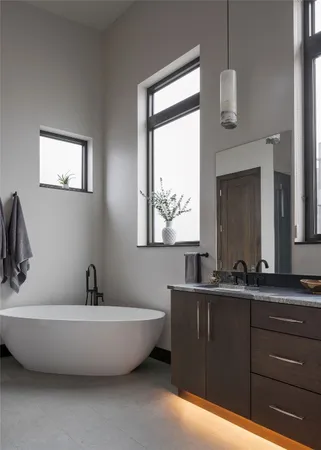a bathroom with a bathtub a sink and mirror