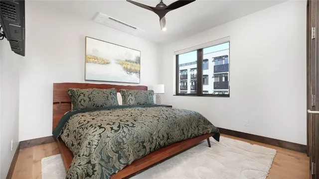 a bedroom with a large bed and a window