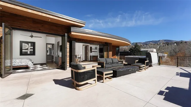 a building outdoor space with patio furniture and potted plants