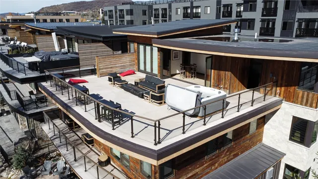 a view of a balcony with chairs and a potted plant