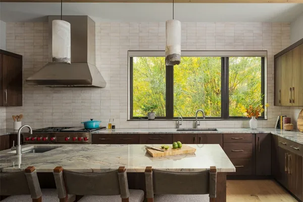 a kitchen with a table chairs sink and cabinets