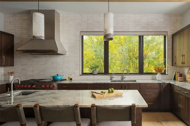 a kitchen with a table chairs sink and cabinets