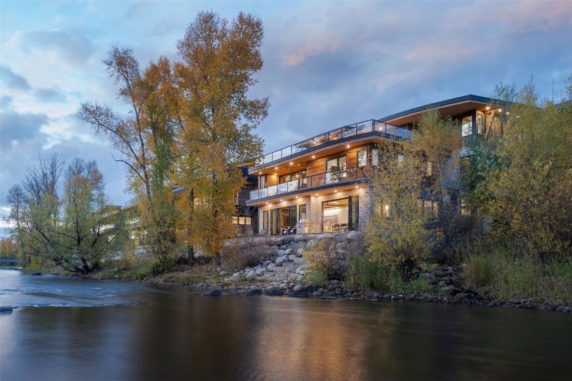 321 Riverview Way Steamboat Springs, CO 80487 - Photo 42 of 50 a front view of a house with lake view and trees all around