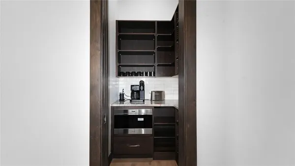a kitchen with a refrigerator and a stove top oven
