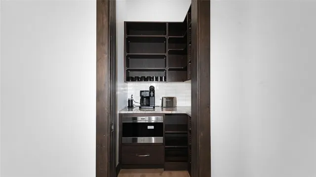 a kitchen with a refrigerator and a stove top oven