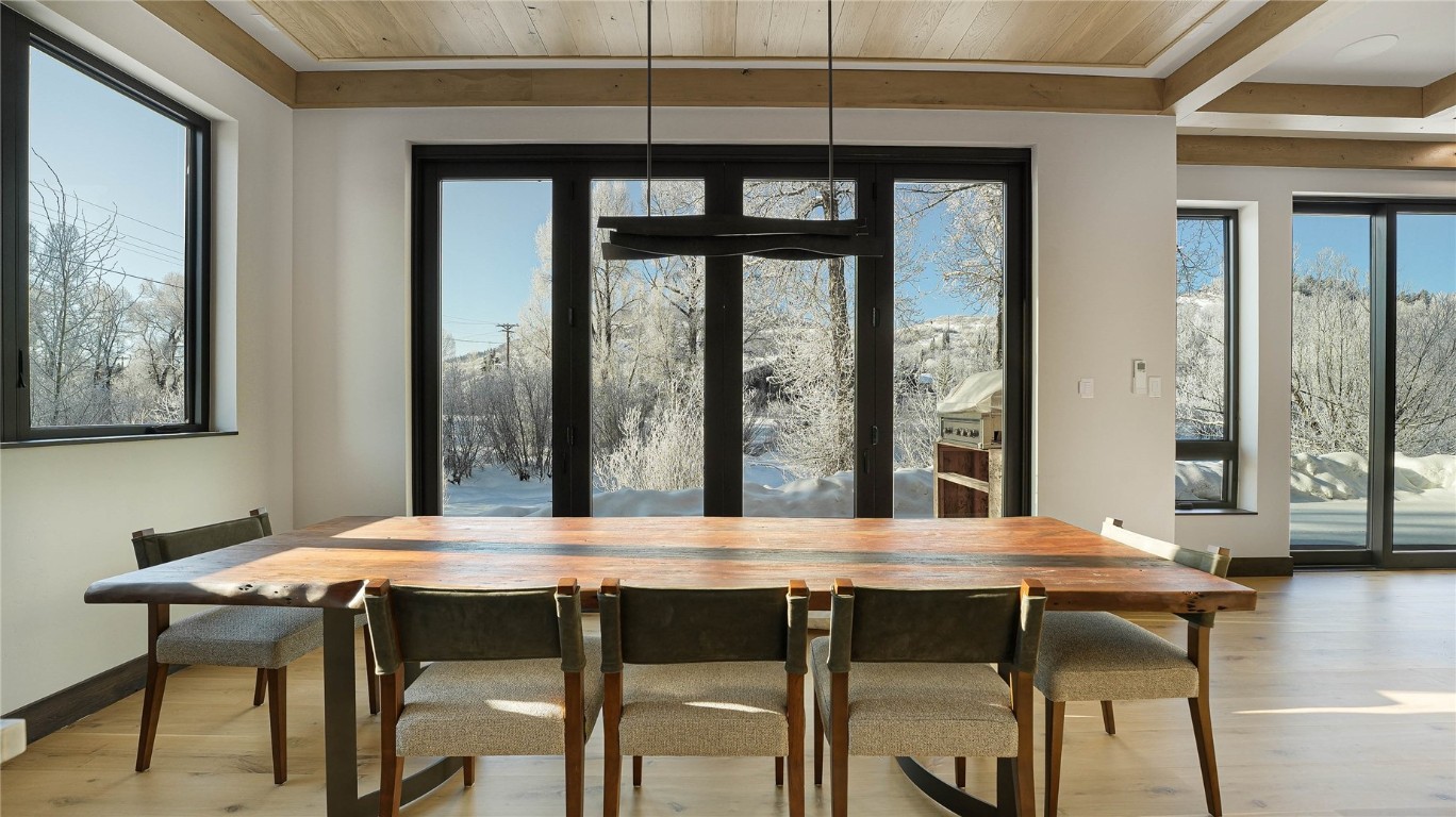 321 Riverview Way Steamboat Springs, CO 80487 - Photo 7 of 50 a view of a dining room with furniture window and wooden floor