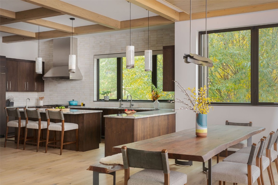 321 Riverview Way Steamboat Springs, CO 80487 - Photo 8 of 50 a kitchen with a table chairs sink and cabinets
