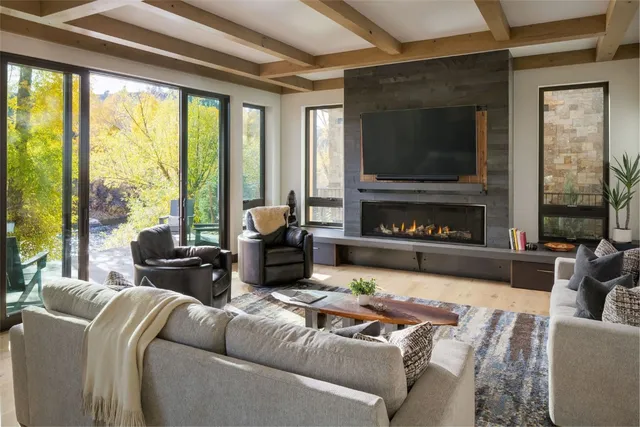 a living room with furniture a flat screen tv and a fireplace