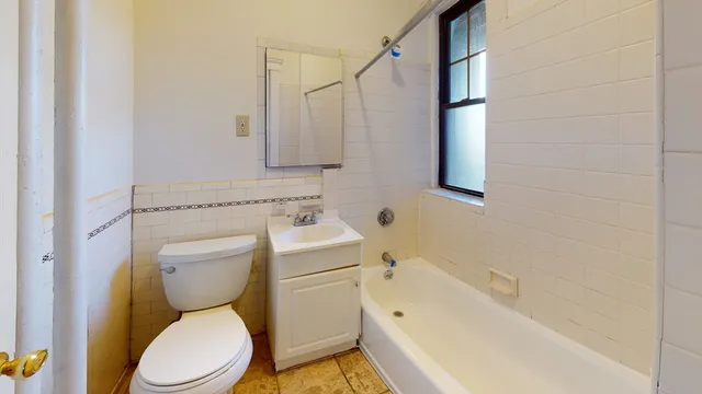 a bathroom with a sink a toilet and bathtub