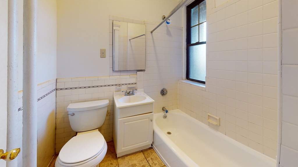 185 Chestnut Hill Avenue, Unit 5 Boston, MA 02135 - Photo 6 of 7 a bathroom with a sink a toilet and bathtub