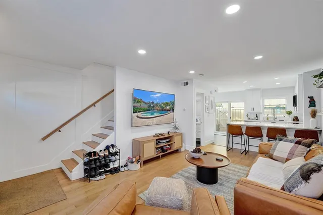 a living room with furniture and a potted plant