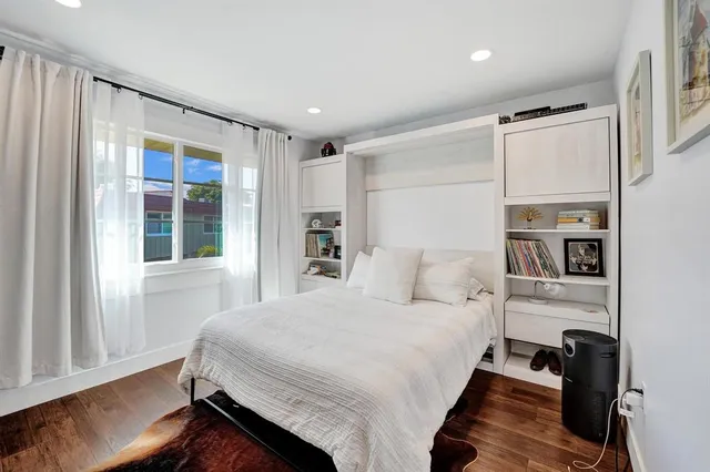 a bedroom with a large bed and a window