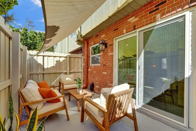 a view of a patio with a table and chairs