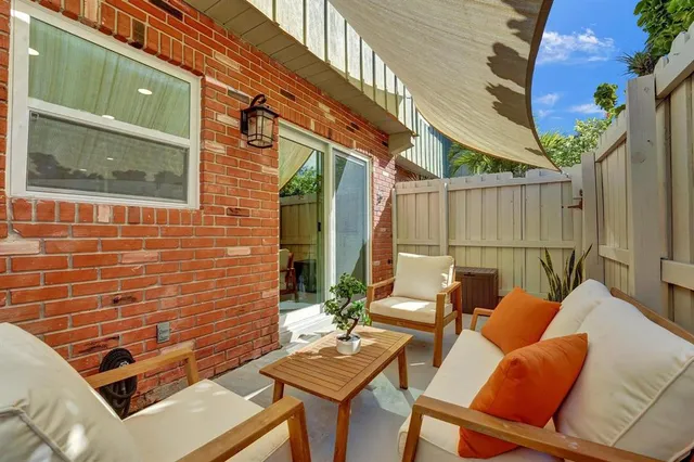 a backyard of a house with outdoor seating