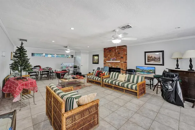 a living room with furniture a rug and a chandelier