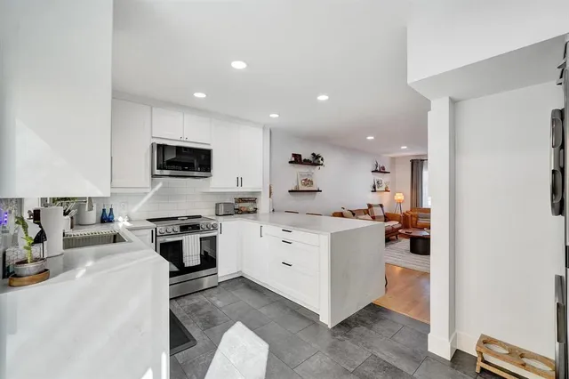 a kitchen with a sink stove top oven and microwave