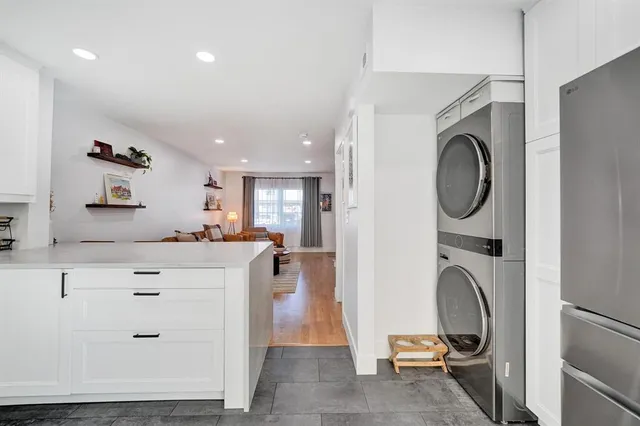 a view of a kitchen with a sink a washer and dryer