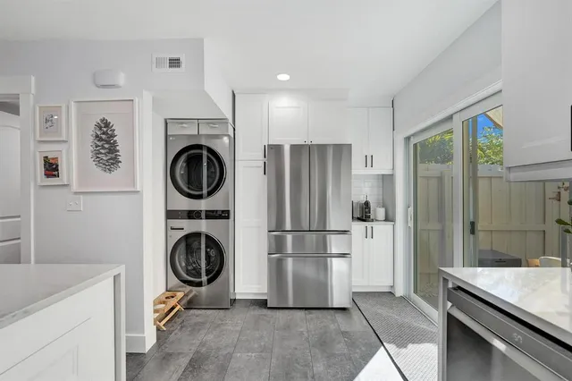 a view of kitchen cabinetry and refrigerator