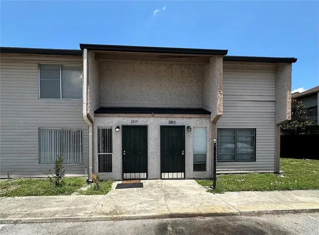 a view of a brick house with many windows