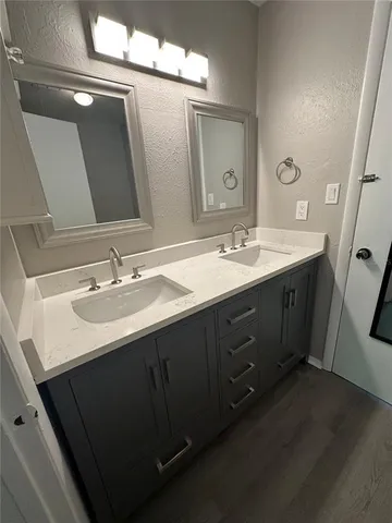 a bathroom with a double vanity sink and mirror