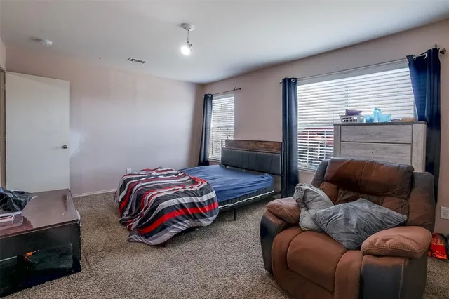 a bedroom with furniture and a fireplace