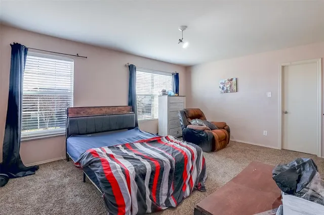 a bedroom with two beds and a window
