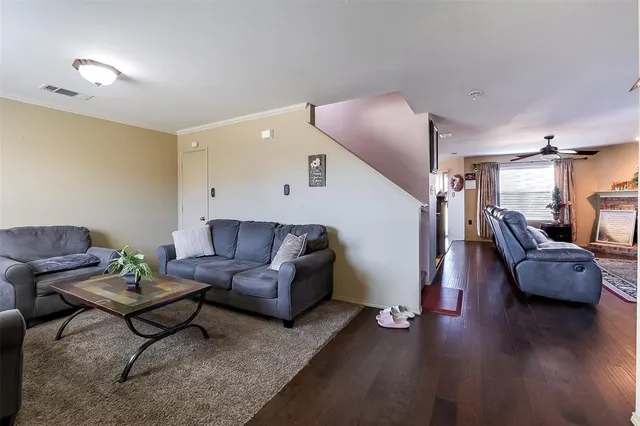 a living room with furniture and wooden floor