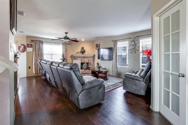 a living room with fireplace furniture and a wooden floor