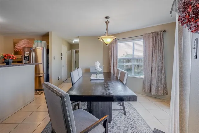 a dining room with furniture window and wooden floor