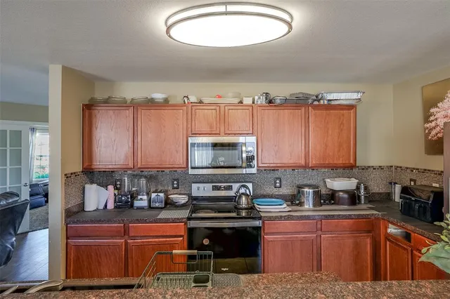 a kitchen with a stove a sink and a microwave