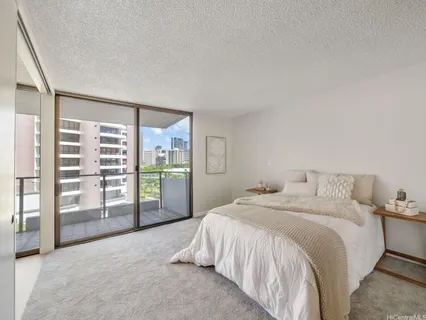 a spacious bedroom with a bed and a large window