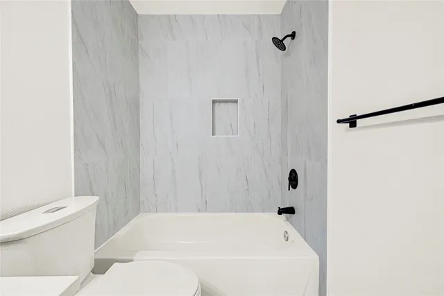 a bathroom with a bathtub and a toilet