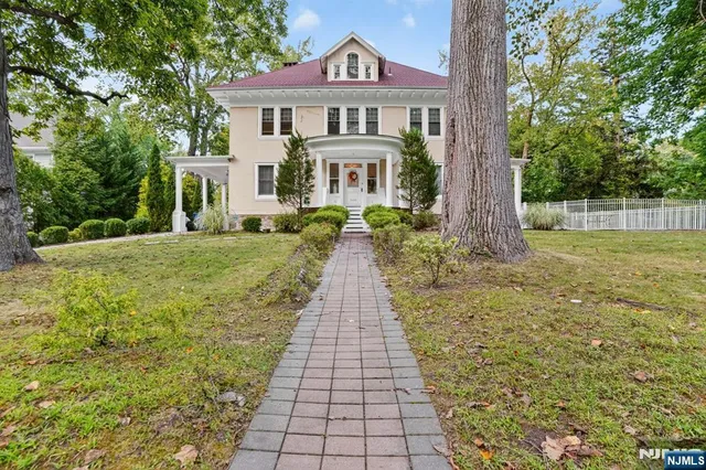 a front view of a house with a garden