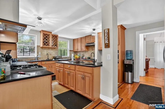 a kitchen with stainless steel appliances granite countertop a refrigerator and a stove top oven