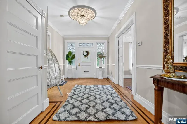 a view of a hallway to a livingroom with furniture